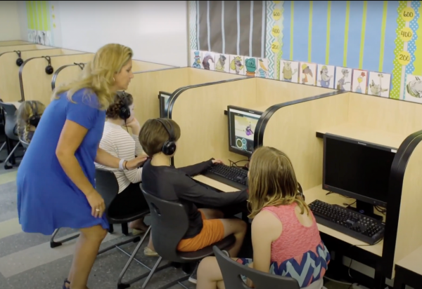 A teacher supervises her students as they work with ClearFluency