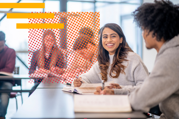 Native and heritage Spanish-speaking students talking to each other while seating at a table.